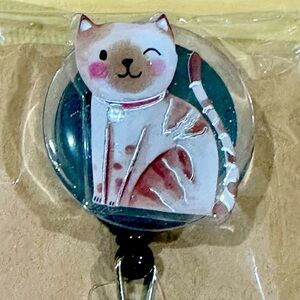 Winky cat badge reel with belt clip
